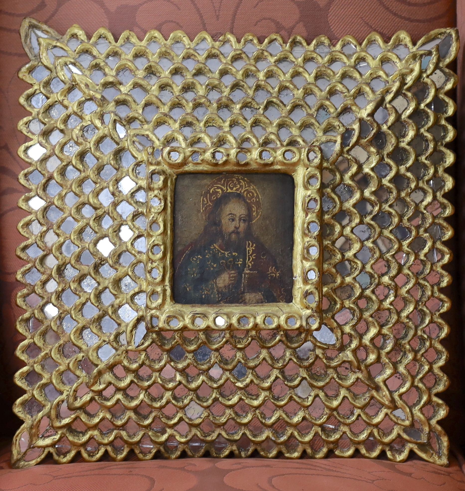 Cusco School, oil on panel, Saint holding a bible, 12 x 11cm, ornate mirrored frame